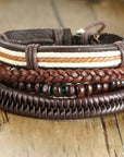 4Pcs/Set braided leather bracelets with wooden beads and rustic charms, including life tree and rudder designs, offering a vintage tribal-inspired look with braided patterns and durable leather for a stylish, ethnic accessory.