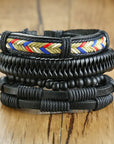 4Pcs/Set braided leather bracelets with wooden beads and rustic charms, including life tree and rudder designs, offering a vintage tribal-inspired look with braided patterns and durable leather for a stylish, ethnic accessory.