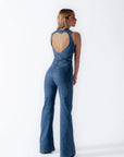 Heart cutout jumpsuit Backless jumpsuit Romantic jumpsuit Figure-flattering jumpsuit Special occasion attire Elegant jumpsuit Eye-catching outfit Fashion-forward jumpsuit Playful back detail Head-turning style