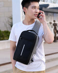 Anti-theft crossbody sling bag made from durable polyester, featuring a USB charging port, computer pocket, and soft surface. Ideal for secure storage and on-the-go charging, with a stylish, casual design and car suture detail.