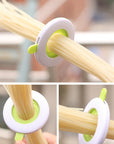 Close-up of a durable plastic spaghetti portion tool used for accurately measuring pasta portions, featuring a compact and easy-to-use design. Ideal as a pasta measuring tool, spaghetti measuring tool, spaghetti measurer, and versatile pasta measurer tool for home kitchens.