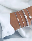 Elegant anklet bracelet featuring a star and moon design, with geometric, love, and flower elements. Includes turtle charm and beaded accents for a unique, boho-inspired look perfect for special occasions like weddings, anniversaries, and birthdays