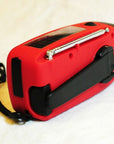Solar hand crank radio with USB charging port, red in color. Features include a Midland Weather Alert Radio, hand crank radio flashlight, and solar charging capabilities, designed for emergency preparedness and outdoor use.