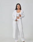 Cozy 3-piece pajama set for women, featuring a soft crop top, wide-leg pants, and a matching knee-length pullover in pastel colors.