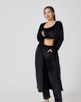 Cozy 3-piece pajama set for women, featuring a soft crop top, wide-leg pants, and a matching knee-length pullover in pastel colors.