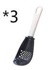 Close-up of a multifunctional slotted spoon grinding cooking spoon, showcasing its innovative design for mashing garlic, ginger, and potatoes, doubling as a stir-frying spatula and versatile kitchen gadget.