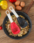 Close-up of a multifunctional slotted spoon grinding cooking spoon, showcasing its innovative design for mashing garlic, ginger, and potatoes, doubling as a stir-frying spatula and versatile kitchen gadget.