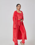 Cozy 3-piece pajama set for women, featuring a soft crop top, wide-leg pants, and a matching knee-length pullover in pastel colors.