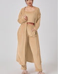 Cozy 3-piece pajama set for women, featuring a soft crop top, wide-leg pants, and a matching knee-length pullover in pastel colors.