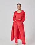 Cozy 3-piece pajama set for women, featuring a soft crop top, wide-leg pants, and a matching knee-length pullover in pastel colors.