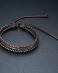 4Pcs/Set braided leather bracelets with wooden beads and rustic charms, including life tree and rudder designs, offering a vintage tribal-inspired look with braided patterns and durable leather for a stylish, ethnic accessory.