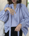 Women's bow stand collar blouse, Blouse with lantern sleeves for women, Women's elegant bow blouse, Lantern sleeve blouse with stand collar, Stylish blouse for ladies with bow detail, Feminine top with lantern sleeves, Women's fashion blouse with bow neckline, Stand collar blouse with bow accent, Chic blouse with lantern sleeves for females, Women's trendy top with bow and lantern sleeves,