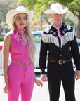 A Barbie Cowboy Costume featuring a vibrant pink cowgirl hat and accessories, perfect for Halloween or Barbie-themed parties