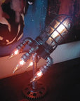 Vintage steampunk rocket lamp with intricate detailing and a glowing flame night light. This unique rocket ship lamp adds retro-futuristic charm to any room, perfect for use as a steampunk desk lamp, or stylish lighting for your bar, store, or office. Featuring high-quality craftsmanship and an E26 bulb for bright illumination, this steampunk lighting fixture enhances any space with its vintage appeal