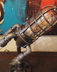 Vintage steampunk rocket lamp with intricate detailing and a glowing flame night light. This unique rocket ship lamp adds retro-futuristic charm to any room, perfect for use as a steampunk desk lamp, or stylish lighting for your bar, store, or office. Featuring high-quality craftsmanship and an E26 bulb for bright illumination, this steampunk lighting fixture enhances any space with its vintage appeal.