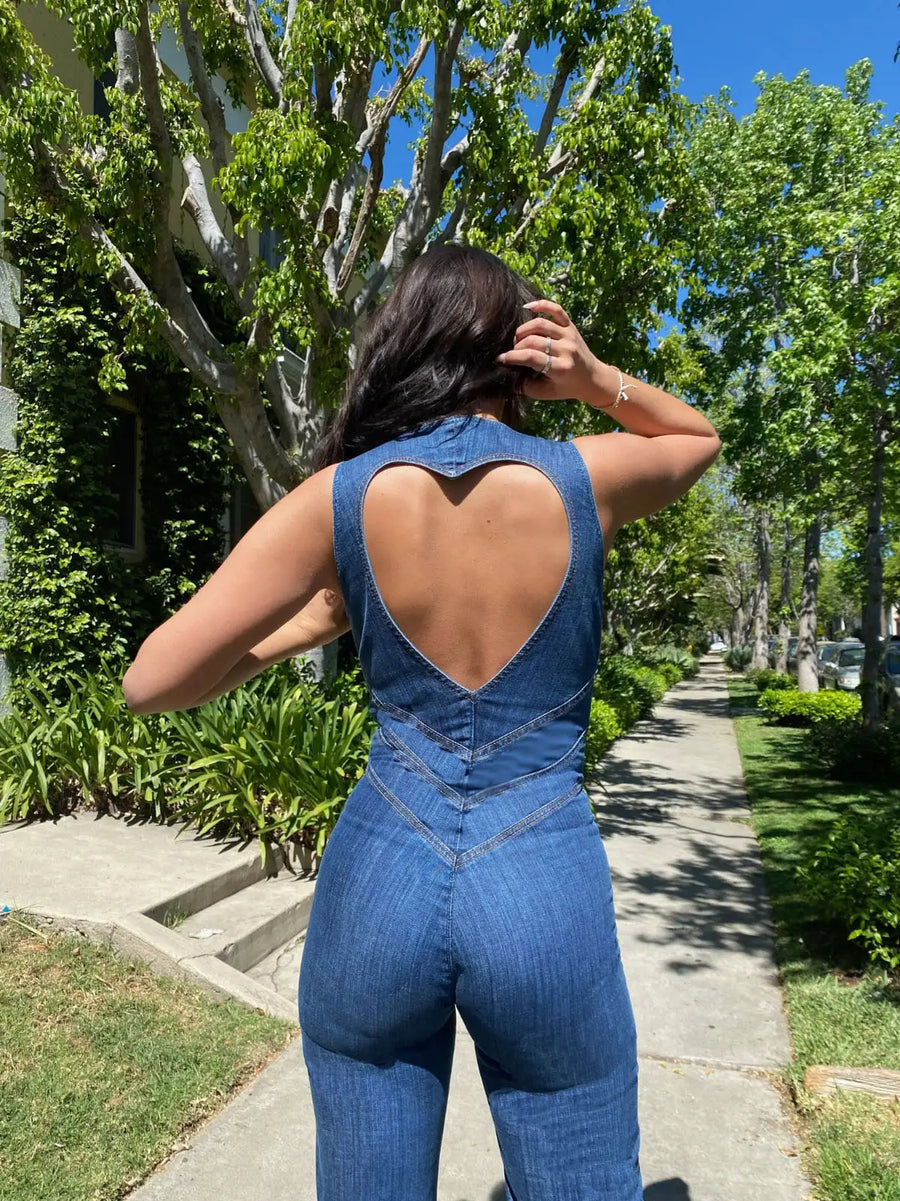 Heart cutout jumpsuit Backless jumpsuit Romantic jumpsuit Figure-flattering jumpsuit Special occasion attire Elegant jumpsuit Eye-catching outfit Fashion-forward jumpsuit Playful back detail Head-turning style