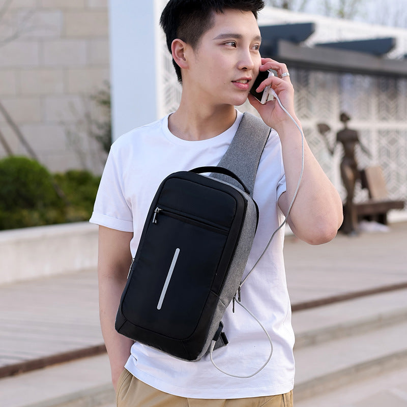 Anti-theft crossbody sling bag made from durable polyester, featuring a USB charging port, computer pocket, and soft surface. Ideal for secure storage and on-the-go charging, with a stylish, casual design and car suture detail.