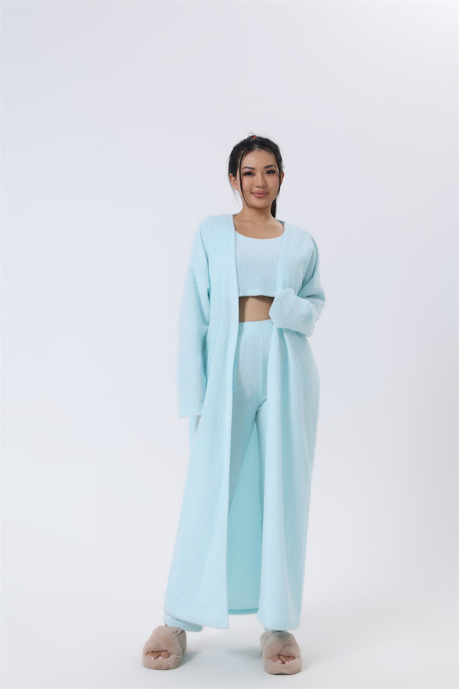 Cozy 3-piece pajama set for women, featuring a soft crop top, wide-leg pants, and a matching knee-length pullover in pastel colors.