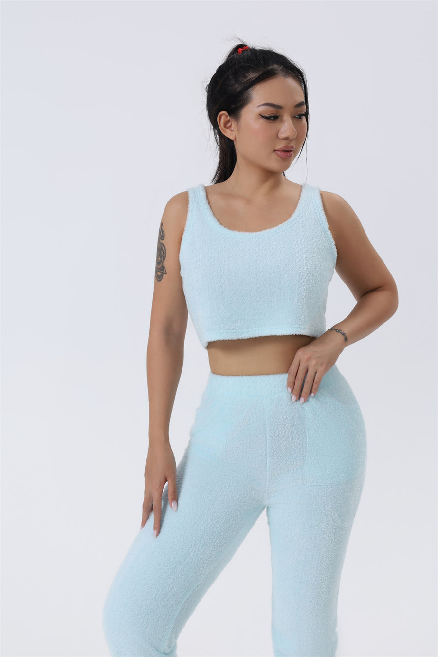 Cozy 3-piece pajama set for women, featuring a soft crop top, wide-leg pants, and a matching knee-length pullover in pastel colors.