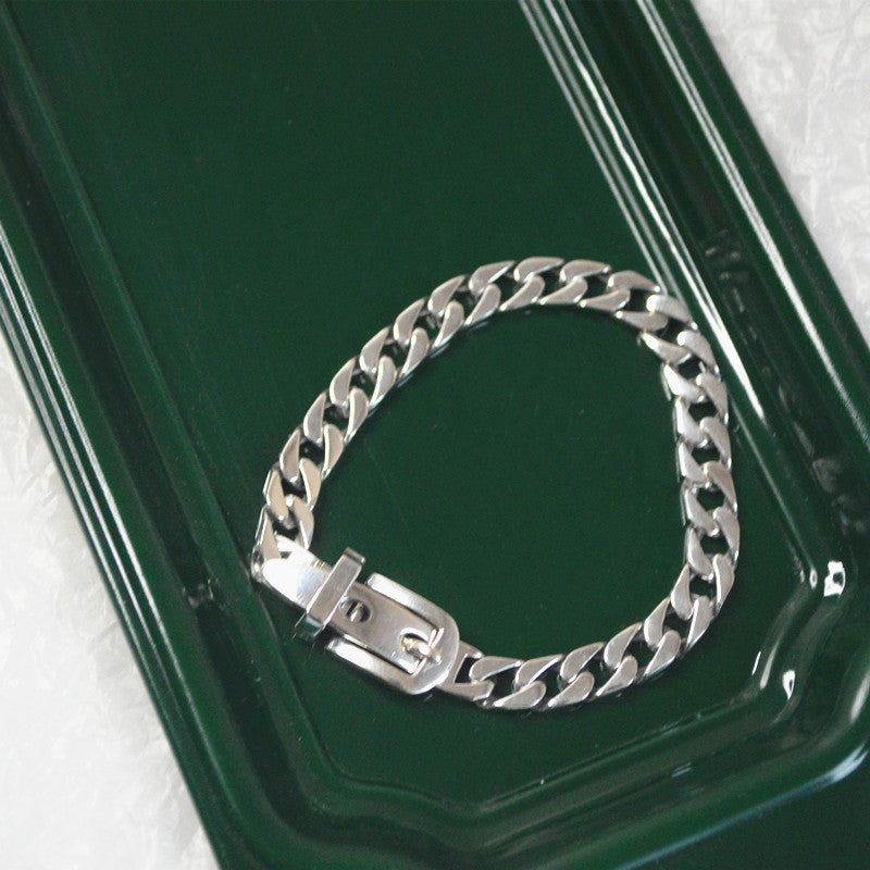 Elegant sterling silver belt bracelet with geometric design and platinum plating, featuring a unique belt buckle style.