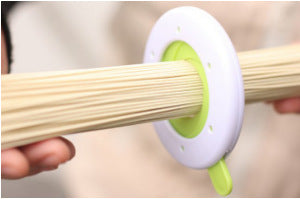 Close-up of a durable plastic spaghetti portion tool used for accurately measuring pasta portions, featuring a compact and easy-to-use design. Ideal as a pasta measuring tool, spaghetti measuring tool, spaghetti measurer, and versatile pasta measurer tool for home kitchens.