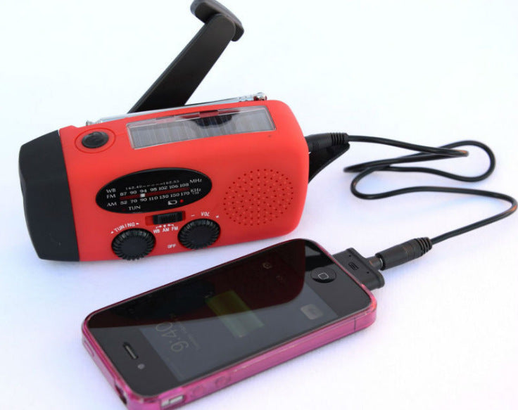 Solar hand crank radio with USB charging port, red in color. Features include a Midland Weather Alert Radio, hand crank radio flashlight, and solar charging capabilities, designed for emergency preparedness and outdoor use.