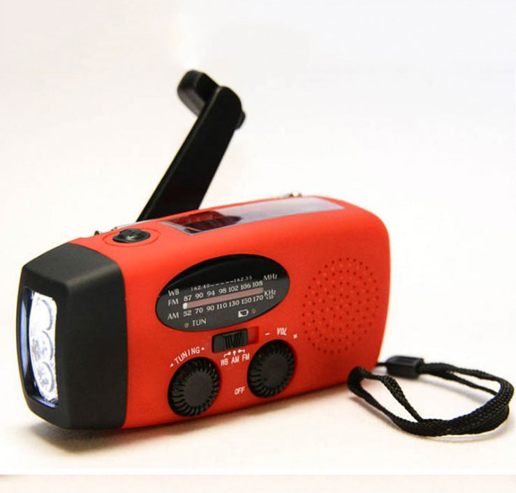 Solar hand crank radio with USB charging port, red in color. Features include a Midland Weather Alert Radio, hand crank radio flashlight, and solar charging capabilities, designed for emergency preparedness and outdoor use.