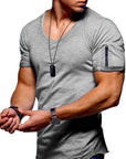 The Men's V-Neck Casual T-Shirt styled with jeans and a blazer for a modern, minimalist look.