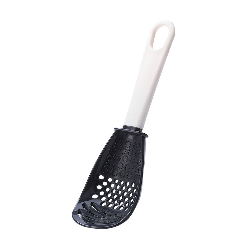 Close-up of a multifunctional slotted spoon grinding cooking spoon, showcasing its innovative design for mashing garlic, ginger, and potatoes, doubling as a stir-frying spatula and versatile kitchen gadget.