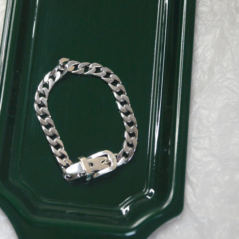 Elegant sterling silver belt bracelet with geometric design and platinum plating, featuring a unique belt buckle style.