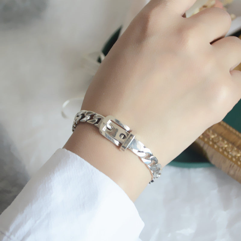 Elegant sterling silver belt bracelet with geometric design and platinum plating, featuring a unique belt buckle style.
