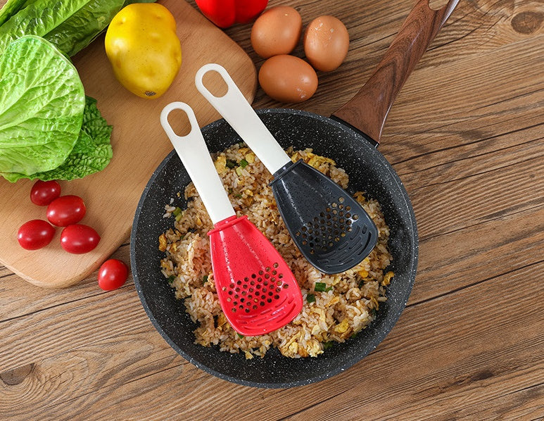 Close-up of a multifunctional slotted spoon grinding cooking spoon, showcasing its innovative design for mashing garlic, ginger, and potatoes, doubling as a stir-frying spatula and versatile kitchen gadget.