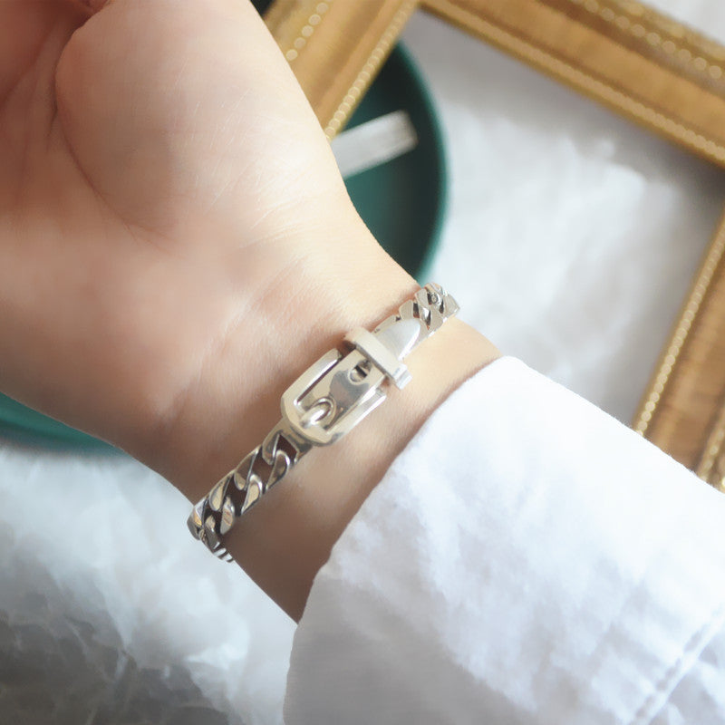 Elegant sterling silver belt bracelet with geometric design and platinum plating, featuring a unique belt buckle style.