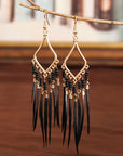 Tassels feather earrings Bohemian feather earrings Fringe feather earrings Statement feather earrings Boho chic earrings Long feather earrings Dangle tassel earrings Trendy feather earrings Fashionable tassel earrings Feather jewelry accessories