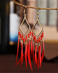 Tassels feather earrings Bohemian feather earrings Fringe feather earrings Statement feather earrings Boho chic earrings Long feather earrings Dangle tassel earrings Trendy feather earrings Fashionable tassel earrings Feather jewelry accessories