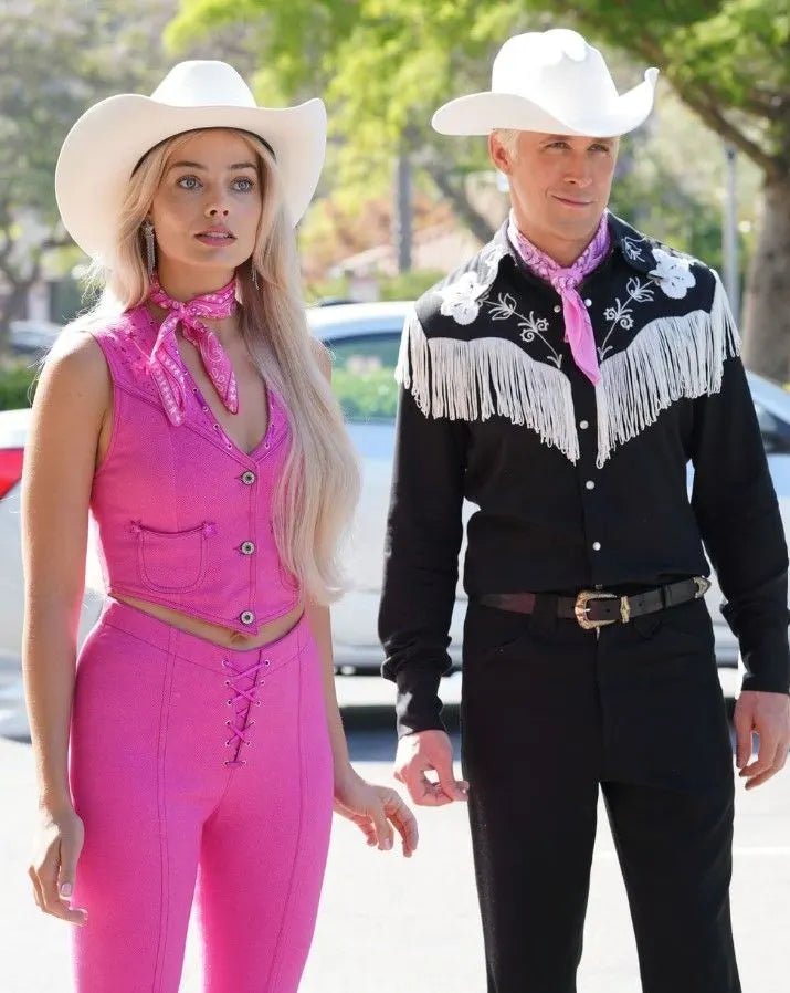  A Barbie Cowboy Costume featuring a vibrant pink cowgirl hat and accessories, perfect for Halloween or Barbie-themed parties
