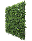 White flowering artificial boxwood wall Artificial boxwood wall with white flowers Faux boxwood wall panel with flowering white blooms Decorative boxwood backdrop with white floral accents Artificial hedge wall featuring white flowering foliage White flower boxwood wall panel for indoor and outdoor decor Lifelike artificial boxwood wall with white blossoms Faux boxwood paneling adorned with white flowers White floral artificial greenery wall for home and event decor