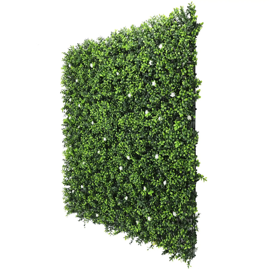 White flowering artificial boxwood wall Artificial boxwood wall with white flowers Faux boxwood wall panel with flowering white blooms Decorative boxwood backdrop with white floral accents Artificial hedge wall featuring white flowering foliage White flower boxwood wall panel for indoor and outdoor decor Lifelike artificial boxwood wall with white blossoms Faux boxwood paneling adorned with white flowers White floral artificial greenery wall for home and event decor