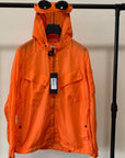 Front view of a hooded lightweight windbreaker coat designed for men and women in waterproof material.