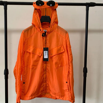 Front view of a hooded lightweight windbreaker coat designed for men and women in waterproof material.