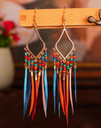 Tassels feather earrings Bohemian feather earrings Fringe feather earrings Statement feather earrings Boho chic earrings Long feather earrings Dangle tassel earrings Trendy feather earrings Fashionable tassel earrings Feather jewelry accessories