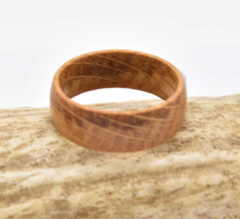 Reclaimed wood ring Whiskey barrel jewelry Rustic barrel ring Handcrafted wood ring Unique wood grain ring Vintage whiskey barrel ring Artisanal barrel wood ring Aged wood band Distinctive barrel ring Heritage-inspired ring